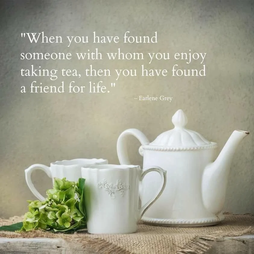 A pot of tea and tea cups with a tea quote.
